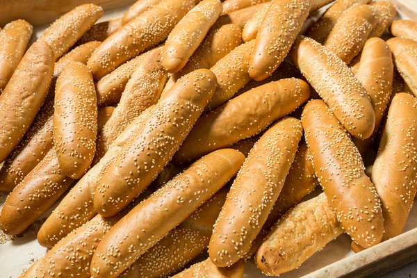 Fresh baked small baguettes  with sesame — Stock Photo, Image