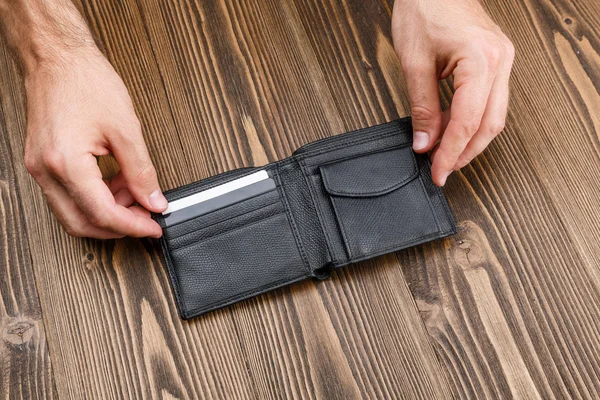 Black man's wallet in man hands