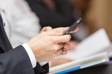 Akıllı telefon kullanan bir iş adamı.