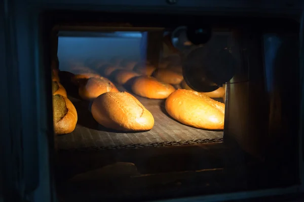 Hot baked breads in the oven — Stock Photo, Image