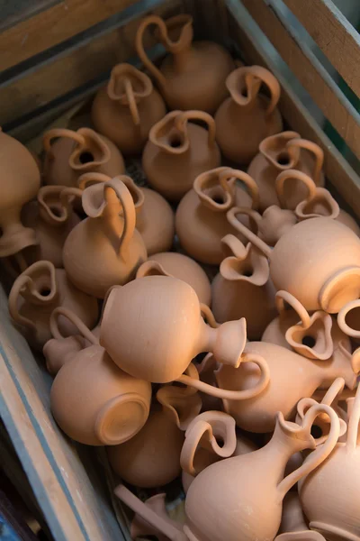 Box with small brown clay jars — Stock Photo, Image