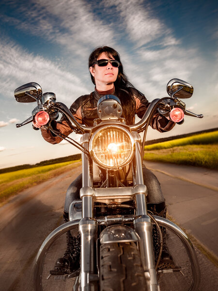 Biker girl sitting on motorcycle