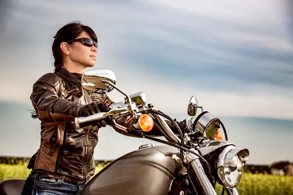 Biker meisje zit op motorfiets — Stockfoto