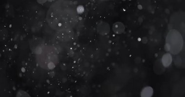 Karanlık arkaplanda soyut parçacık bokeh 'i yüzdürür