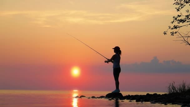 Mulher Pesca Vara Pesca Girando Pôr Sol Fundo — Vídeo de Stock