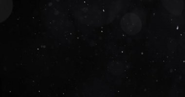 Karanlık arkaplanda soyut parçacık bokeh 'i yüzdürür