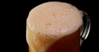 Bira beyaz köpükle bardağa yerleşir.