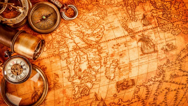 Vintage magnifying glass lies on an ancient world map — Stock Photo, Image