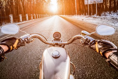 Biker First-person view. Winter slippery road clipart