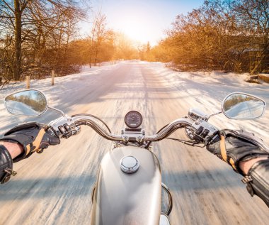 Biker First-person view. Winter slippery road clipart