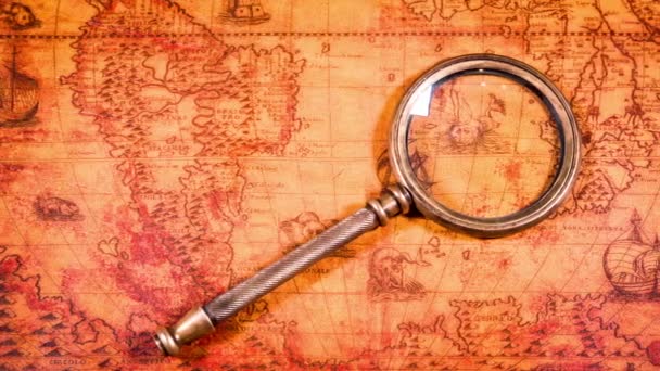 Vintage still life. Vintage magnifying glass lies on ancient world map in 1565. — Stock Video