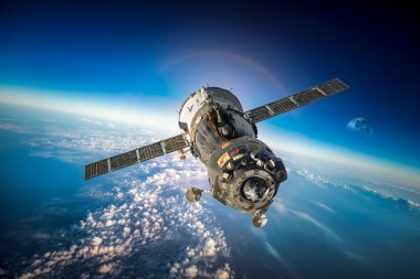 Spacecraft Soyuz over the planet earth