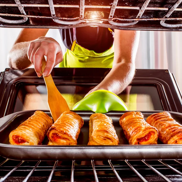 Ama de casa preparando pasteles en el horno — Foto de Stock