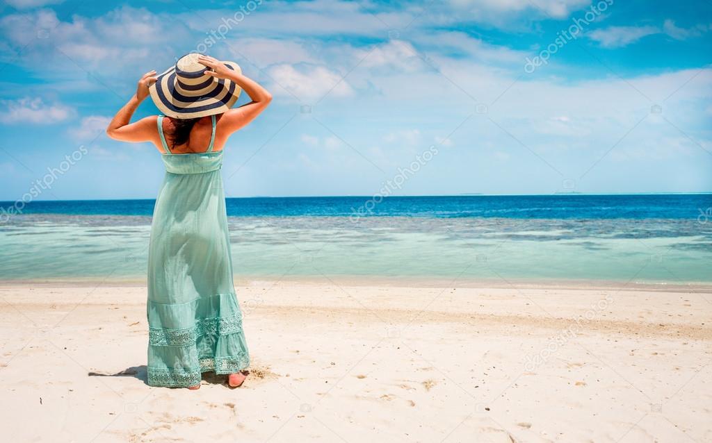 Girl walking along a tropical beach