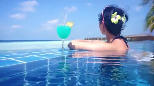 Girl looking at the ocean while sitting by the pool — Stock Video