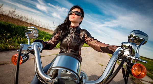 Biker girl sitting on motorcycle