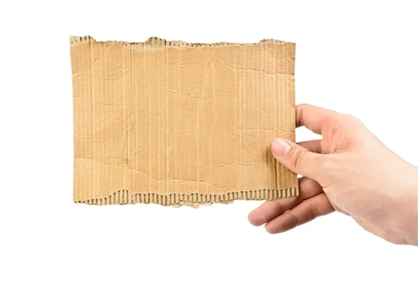 Mão segurando peça de papelão — Fotografia de Stock