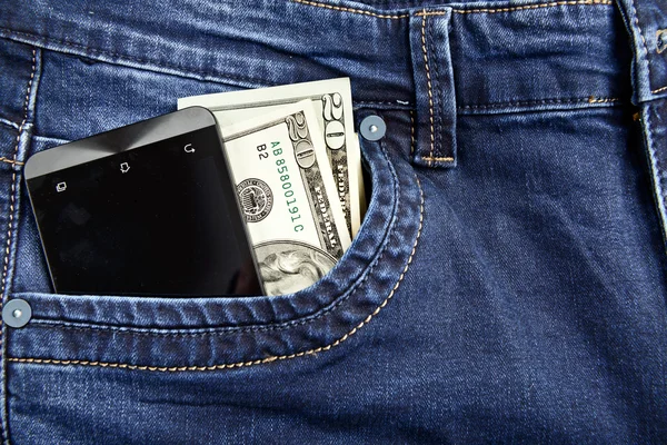 Teléfono con dinero en jeans —  Fotos de Stock