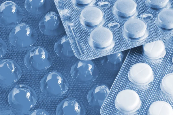 Pílulas médicas com tom azul Fotografias De Stock Royalty-Free
