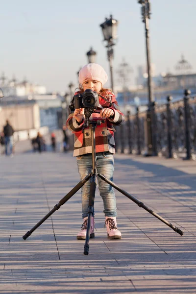 Little girl with the big camera