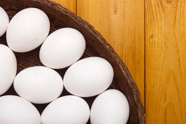 Fresh chicken eggs in a basket — Stock Photo, Image