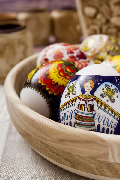 Multi-colored Easter eggs in a wooden bowl — Stock Photo, Image