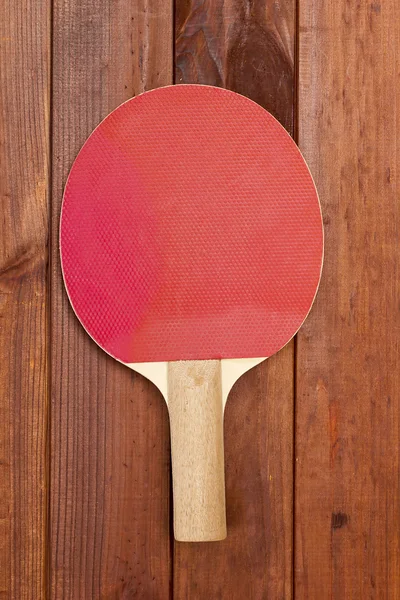 Tennis racket on a wooden table — Stock Photo, Image