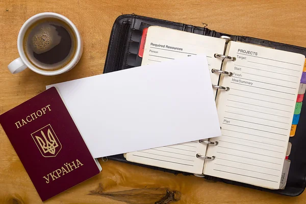 Open diary, passport and a cup of coffee — Stock Photo, Image