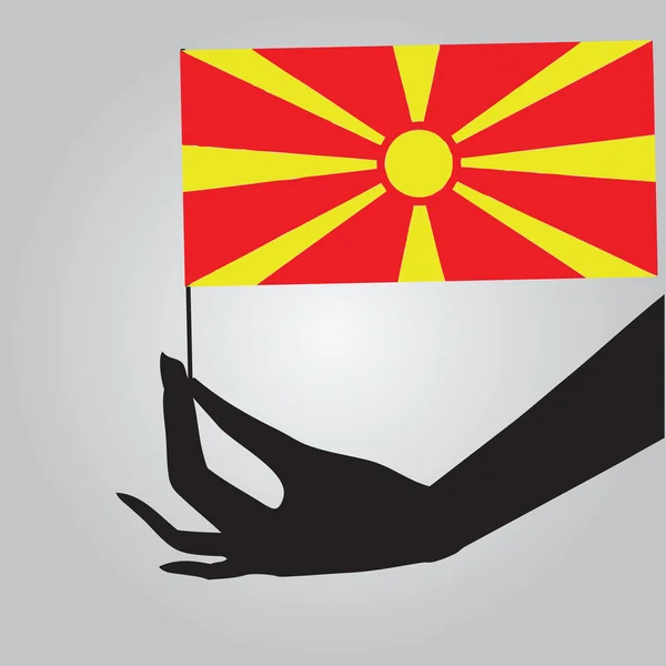 Mano con bandera Macedonia — Vector de stock