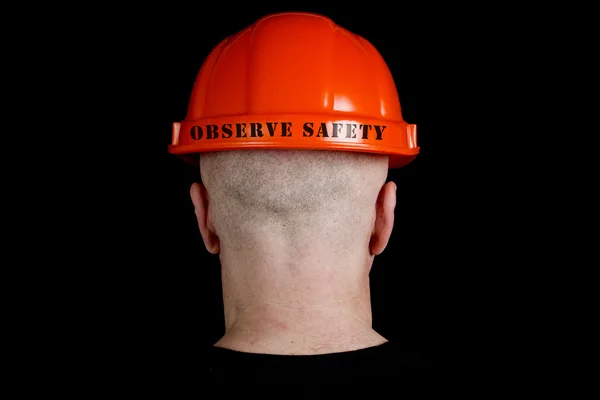 Travailleur de la construction en casque dur avec une inscription observer coffre-fort — Photo