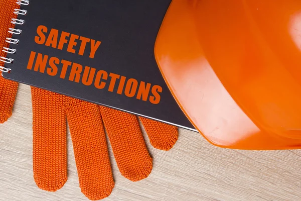 Industriële veiligheid helm, handschoenen en veiligheid boek — Stockfoto