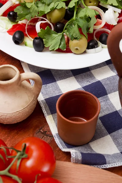 Ceramic cup and Greek salad — Stock Photo, Image