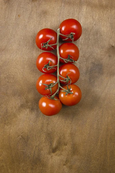 Tomato branch on vintage wood table — Stock Photo, Image