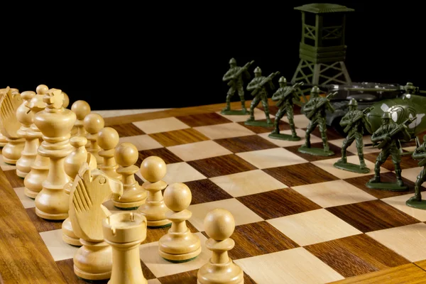 Chess pieces and toy soldiers — Stock Photo, Image