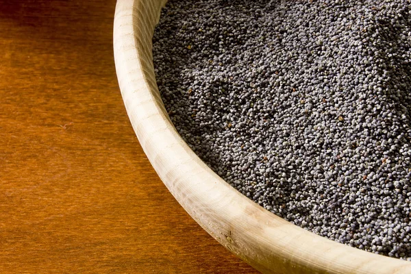 Poppy seeds in a wooden bowl — Stock Photo, Image