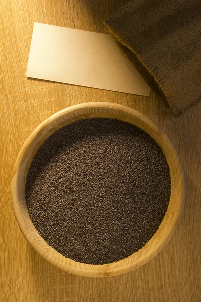 Poppy seeds in a wooden bowl — Stock Photo, Image