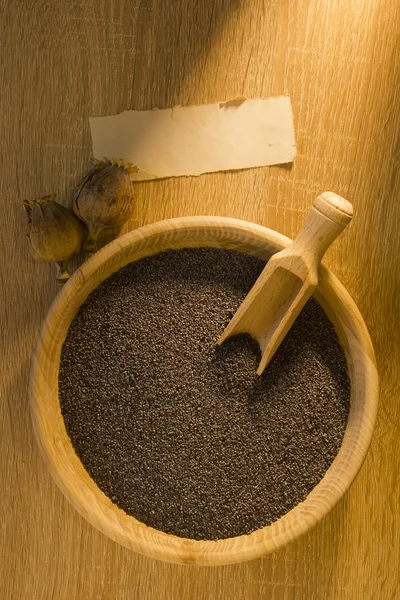 Poppy seeds in a wooden bowl — Stock Photo, Image