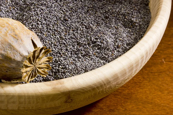 Poppy seeds in a wooden bowl — Stock Photo, Image