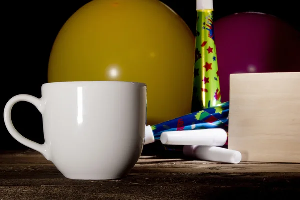 Cup of coffee and inflatable balls — Stock Photo, Image