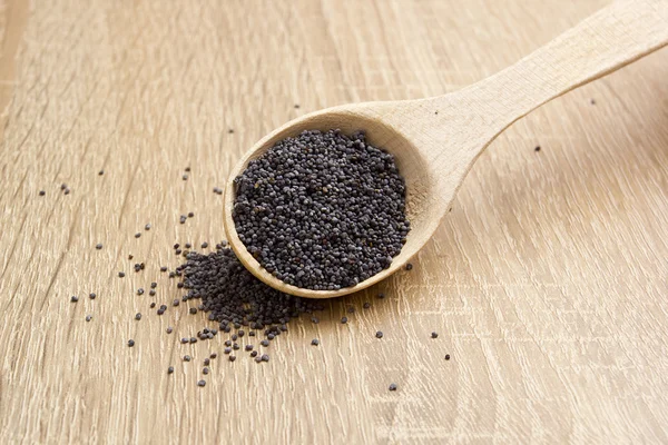 Poppy seeds in a wooden spoon — Stock Photo, Image