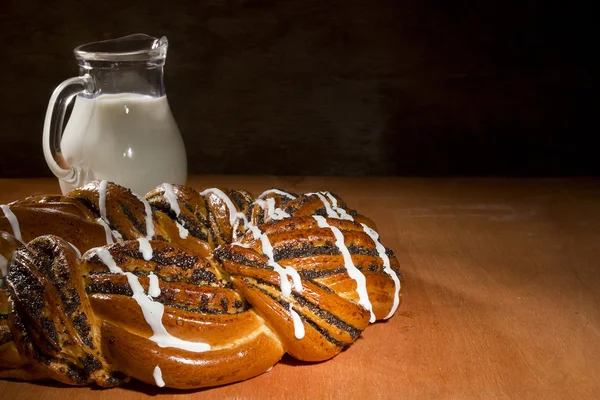 Braided roll with poppy seeds and cinnamon — Stock Photo, Image