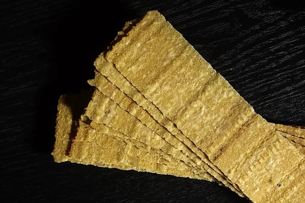 Rectangular Potato Chips Black Wooden Background — Stock Photo, Image