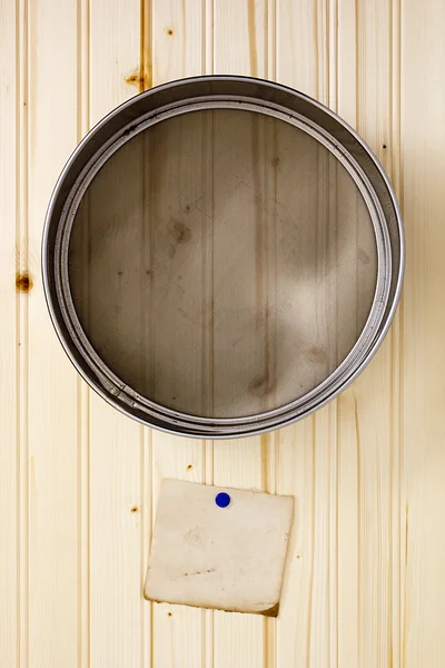 Sieve on a wooden wall — Stock Photo, Image