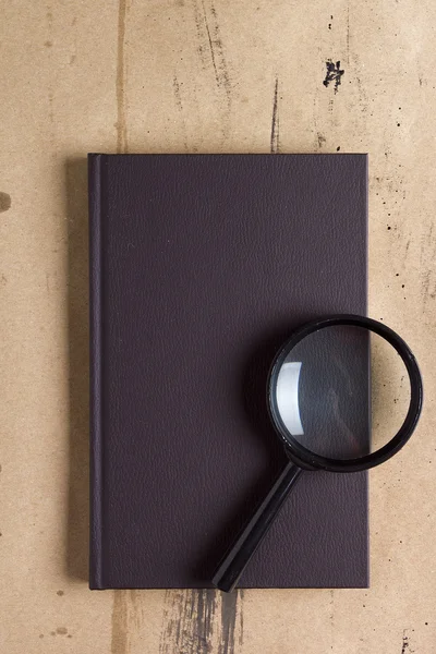 Cover book and magnifying glass — Stock Photo, Image