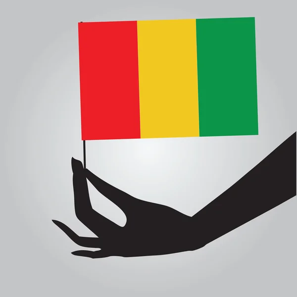 Mano con bandera Guinea — Vector de stock