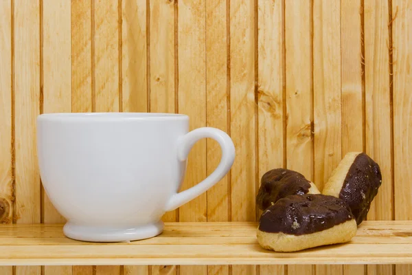 紅茶のカップとミニ エクレア — ストック写真