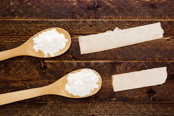 Wooden spoon with flour and starch — Stock Photo, Image