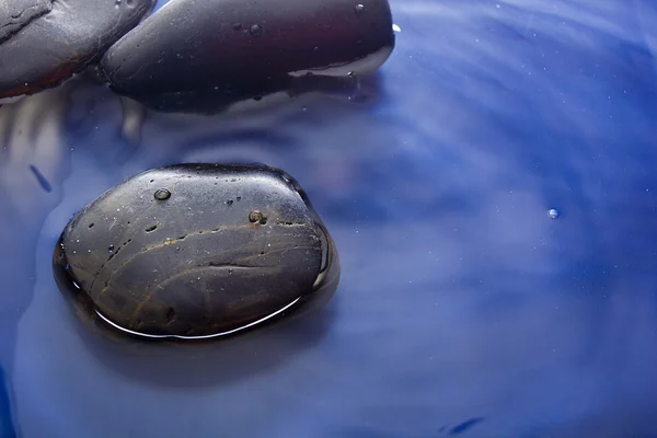 Smooth stones in water — Stock Photo, Image