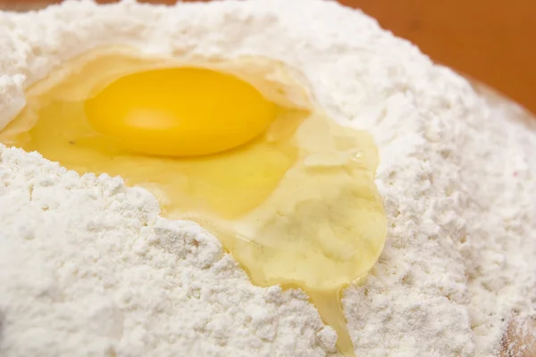 Chicken egg in the flour — Stock Photo, Image