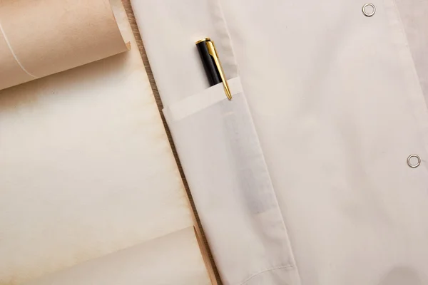 White gown with a pen — Stock Photo, Image